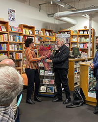 Sue Wootton presents flowers to James
